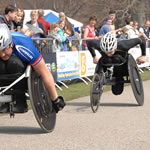 Wheelchair racers near the finish Wheelchair racers near the finish
